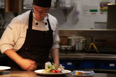 Midsection of man preparing food at restaurant