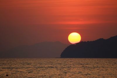 Scenic view of sea against orange sky