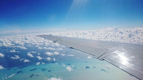 Cropped image of airplane flying over landscape