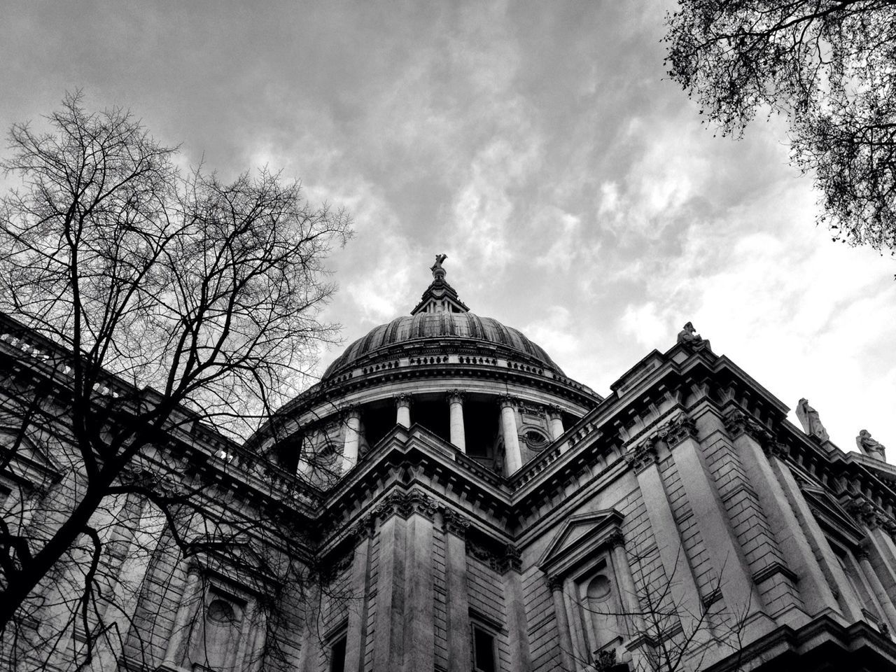 architecture, built structure, building exterior, low angle view, sky, place of worship, religion, dome, spirituality, cloud - sky, church, history, famous place, tree, cathedral, travel destinations, cloudy, cloud