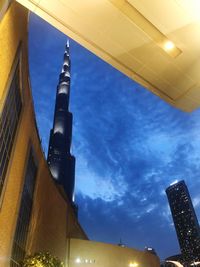 Low angle view of illuminated buildings against sky