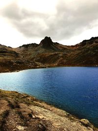 Scenic view of lake and mountains against sky