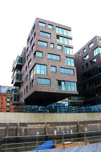 Low angle view of office building against clear sky