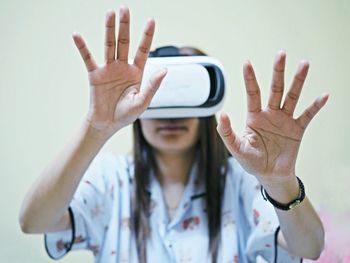 Woman gesturing while using virtual reality simulator