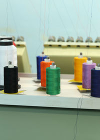 Close-up of multi colored bottles on table