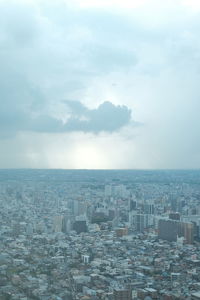 Aerial view of city buildings against sky