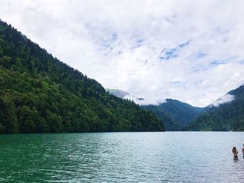 Scenic view of lake and mountains against sky