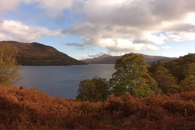 Scenic view of lake and mountains against sky