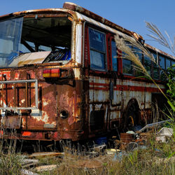 Old abandoned car on field