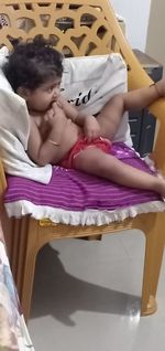High angle view of girl sleeping on bed at home