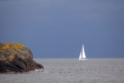 Sailboat on sea against clear sky