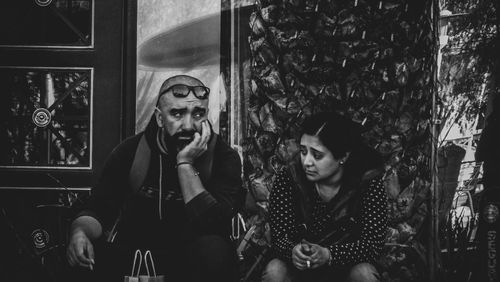 Portrait of young couple sitting at home