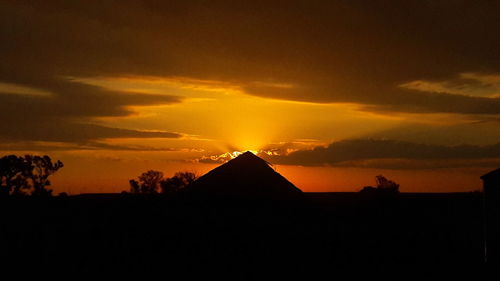 Silhouette of landscape against dramatic sky