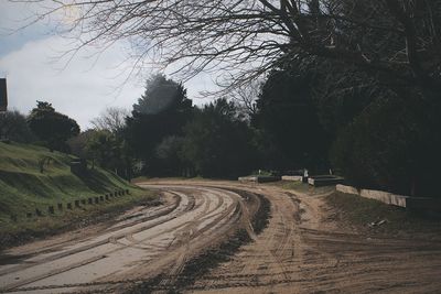 Road amidst trees against sky