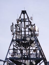 Low angle view of communications tower against clear sky