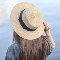 Rear view of woman with hat looking at camera