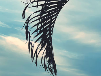 Low angle view of silhouette sculpture against sky