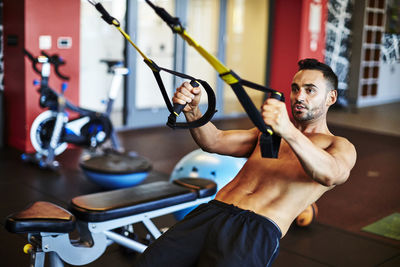 A man working out in a gym.