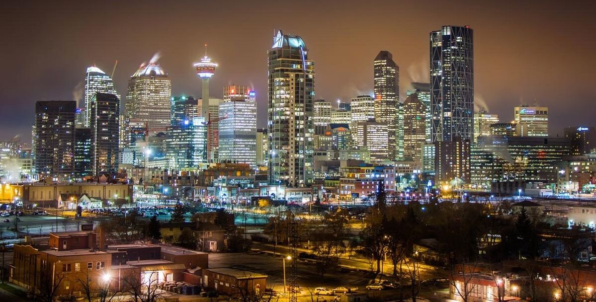 SKYSCRAPERS IN CITY AT NIGHT