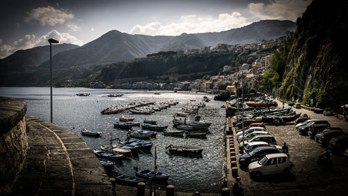 High angle view of boats in lake against cloudy sky