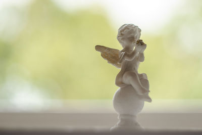 Figurine of cherub on window sill