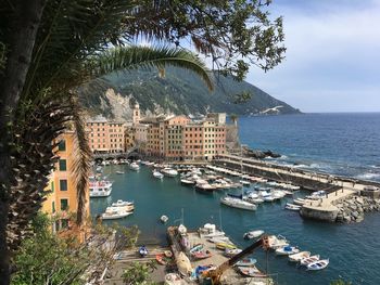 High angle view of sea by city against sky