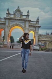 Rear view of young woman standing in city