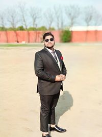 Portrait of young man wearing sunglasses standing outdoors