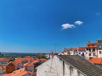 High angle view of townscape against blue sky