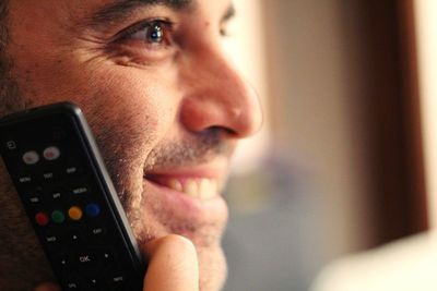 Close-up portrait of young man using mobile phone