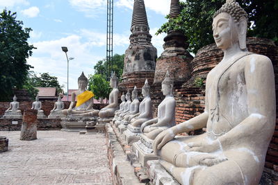 Statues on temple against sky