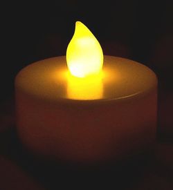 Close-up of illuminated lamp in dark room