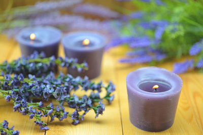 Close-up of scented candles and lavender on table