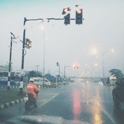 People on wet street in city during rainy season