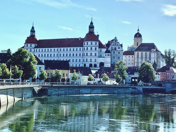 Bridge over river with buildings in background