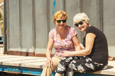 Two elderly women are happy to meet each other