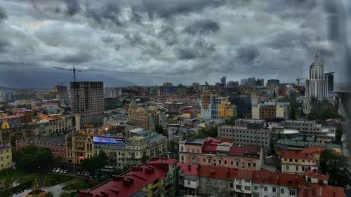 High angle view of cityscape against cloudy sky