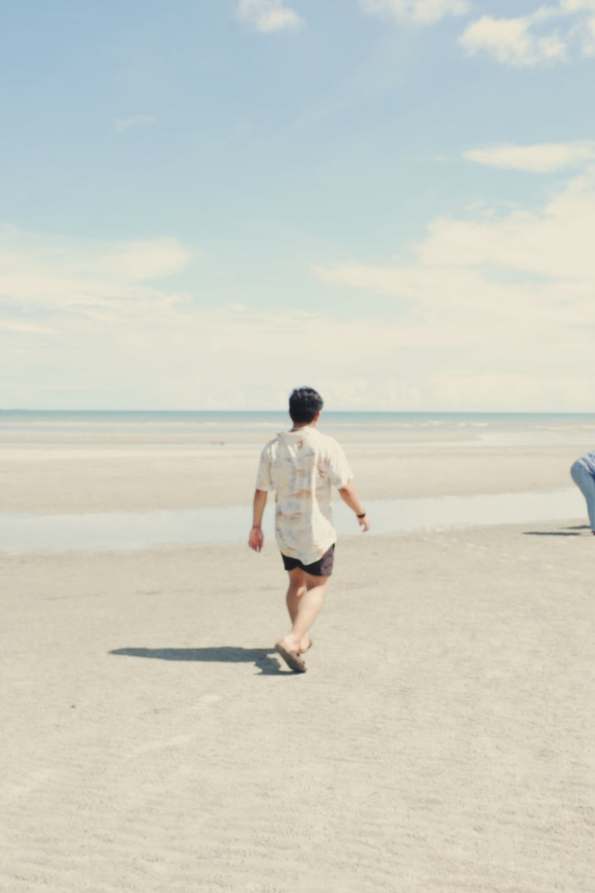 beach, sea, land, sky, water, sand, one person, full length, cloud - sky, rear view, real people, nature, leisure activity, horizon, horizon over water, lifestyles, beauty in nature, running, day, outdoors, shorts