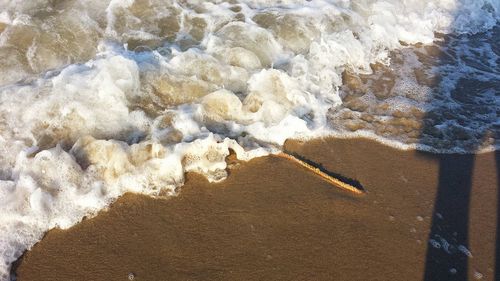 High angle view of surf on beach