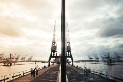 View of harbor against cloudy sky