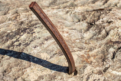 High angle view of rusty metal on rock