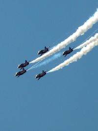 Low angle view of vapor trails in sky