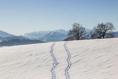 Scenic view of snowcapped mountains against clear sky