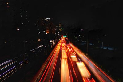 High angle view of light trails on road at night