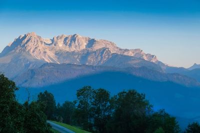 Scenic view of snowcapped mountains against clear blue sky