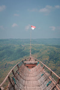 Flags on mountain against sky