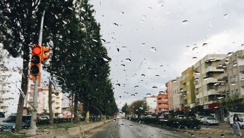 Raindrops on road against sky