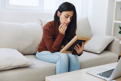 Young woman using laptop at home