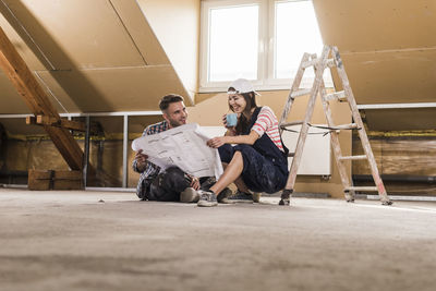 Young couple on construction site of theit new home