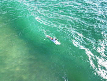 High angle view of people swimming in sea